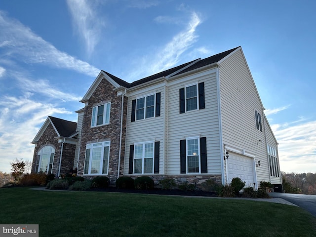 view of front of house featuring a garage and a front lawn