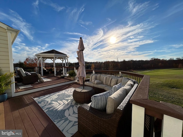 wooden terrace with an outdoor living space and a gazebo