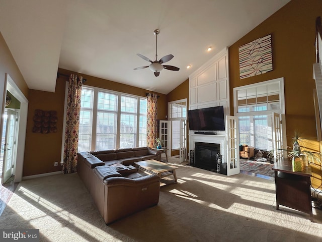 living room featuring high vaulted ceiling, carpet floors, ceiling fan, and french doors