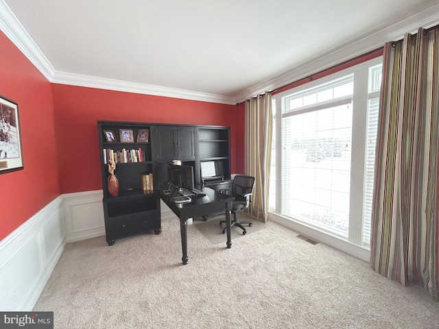 carpeted home office featuring crown molding and a healthy amount of sunlight