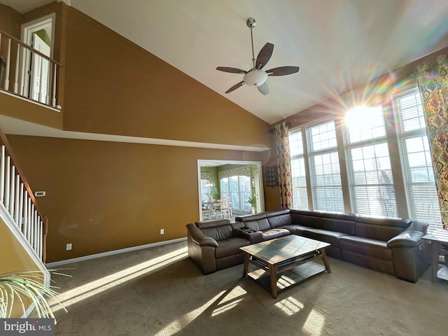 carpeted living room featuring high vaulted ceiling and ceiling fan