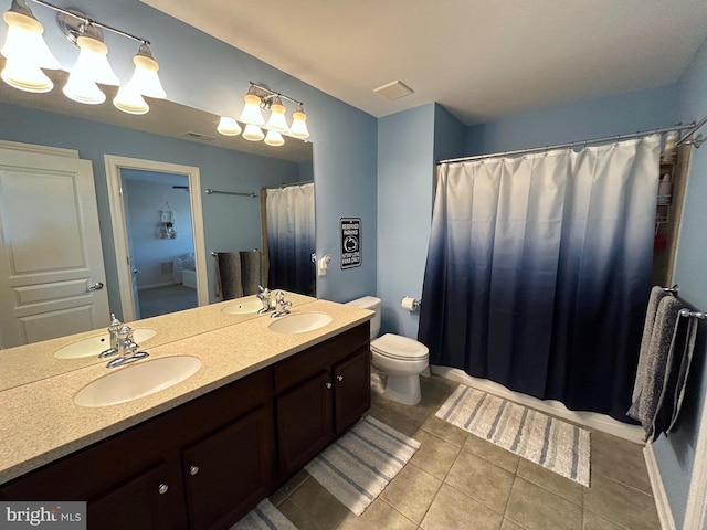 bathroom with vanity, tile patterned flooring, and toilet