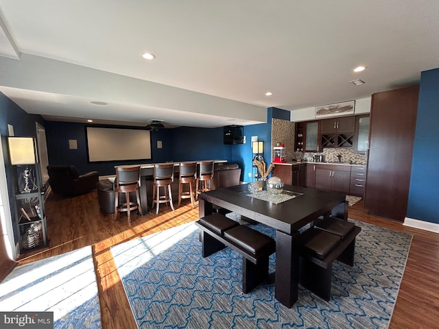 dining area featuring bar area and dark hardwood / wood-style floors