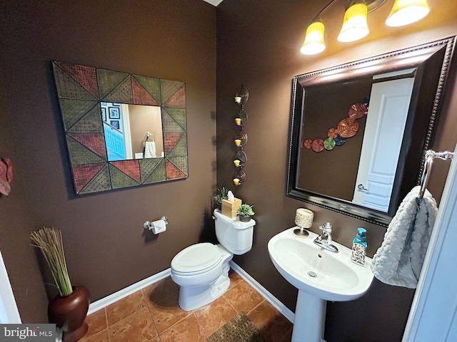 bathroom with sink, tile patterned flooring, and toilet