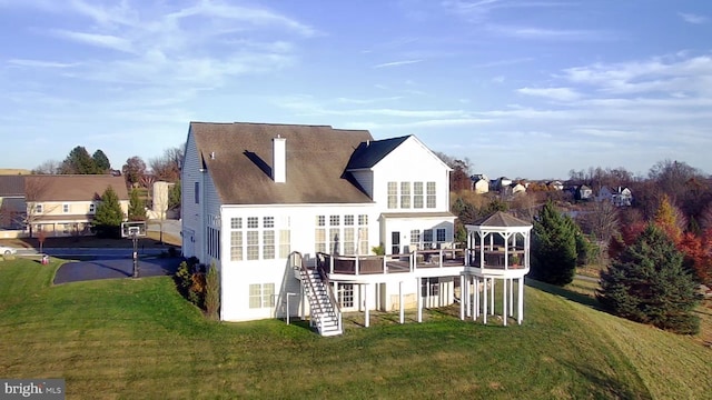 back of house featuring a lawn, a gazebo, and a wooden deck