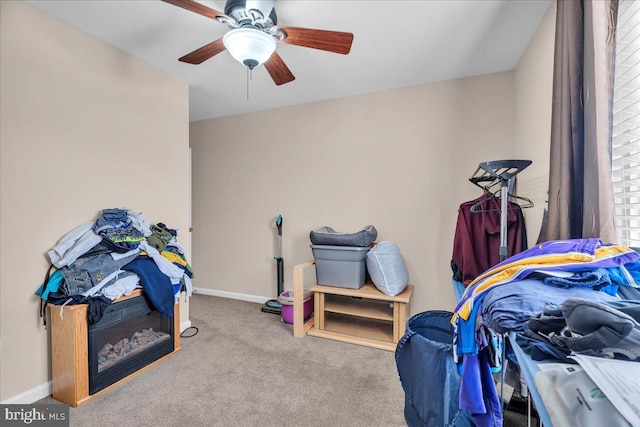 interior space with light carpet and ceiling fan