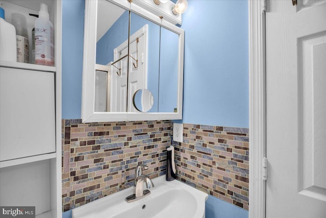 bathroom with decorative backsplash and sink