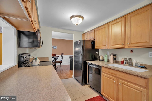 kitchen with light brown cabinetry, sink, black appliances, and light tile patterned flooring