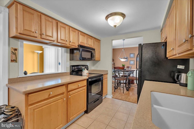 kitchen featuring light tile patterned floors, hanging light fixtures, ornamental molding, black appliances, and sink