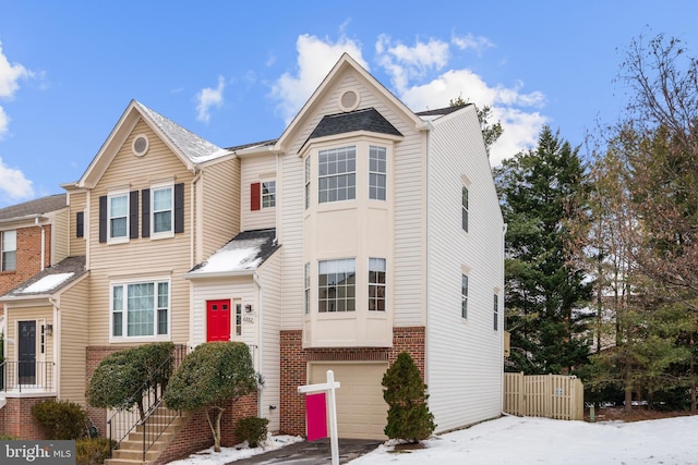 townhome / multi-family property featuring a garage