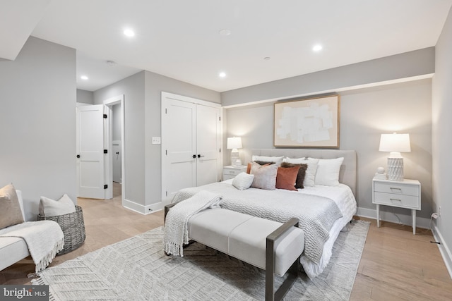 bedroom with a closet and light hardwood / wood-style floors