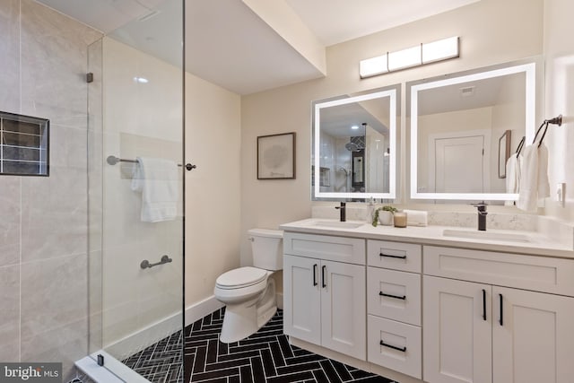 bathroom featuring tile patterned floors, toilet, a shower with door, and vanity