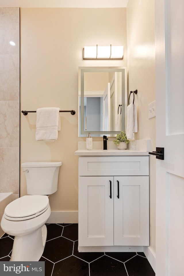 bathroom featuring toilet and vanity