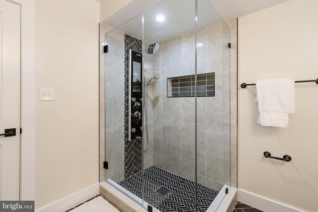 bathroom featuring tile patterned floors and a tile shower