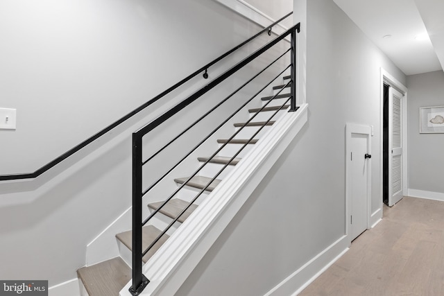 staircase featuring hardwood / wood-style flooring