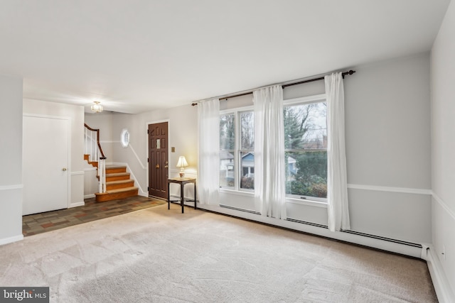 spare room with carpet and a baseboard radiator