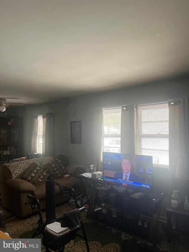 unfurnished living room featuring ceiling fan and a healthy amount of sunlight