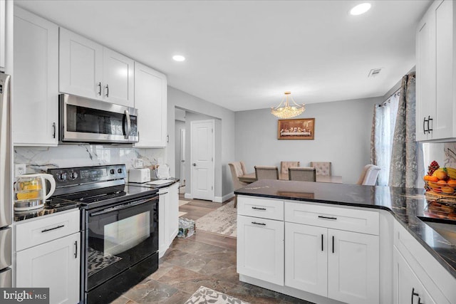 kitchen with white cabinetry, hanging light fixtures, backsplash, and black range with electric cooktop