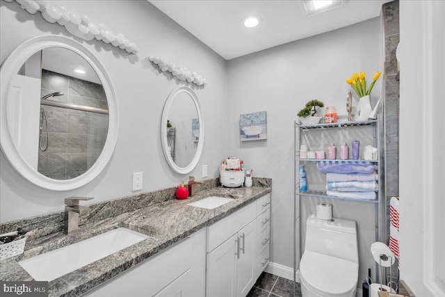 bathroom with toilet, tile patterned flooring, a shower with shower door, and vanity