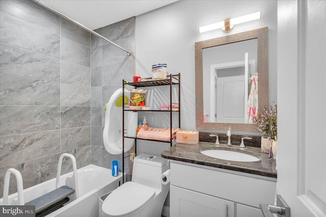 full bathroom featuring toilet, tiled shower / bath combo, and vanity