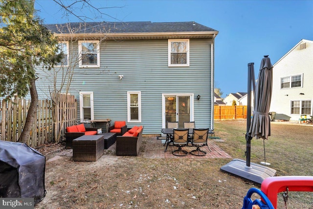 back of house featuring an outdoor hangout area, a patio, and a yard