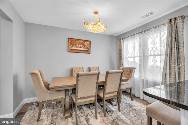 dining room featuring a notable chandelier and wood-type flooring