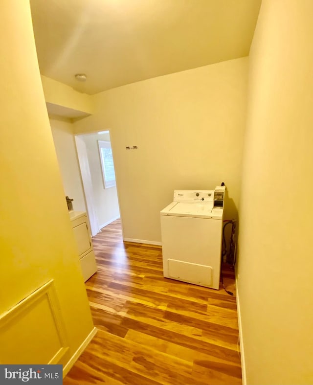 clothes washing area featuring washer / dryer and light hardwood / wood-style floors