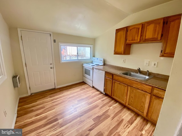 kitchen featuring sink, light hardwood / wood-style floors, white appliances, and vaulted ceiling