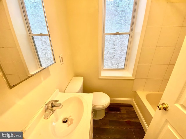 bathroom with sink, toilet, hardwood / wood-style floors, and plenty of natural light