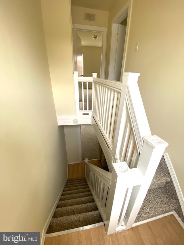 stairway featuring hardwood / wood-style floors