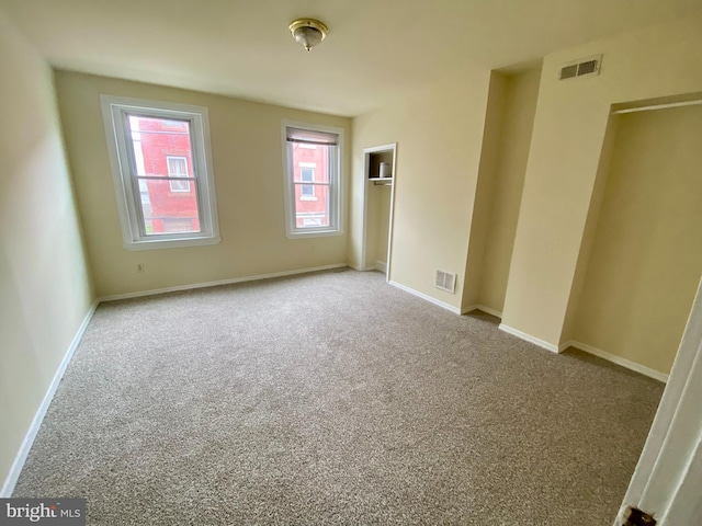 unfurnished bedroom with light colored carpet