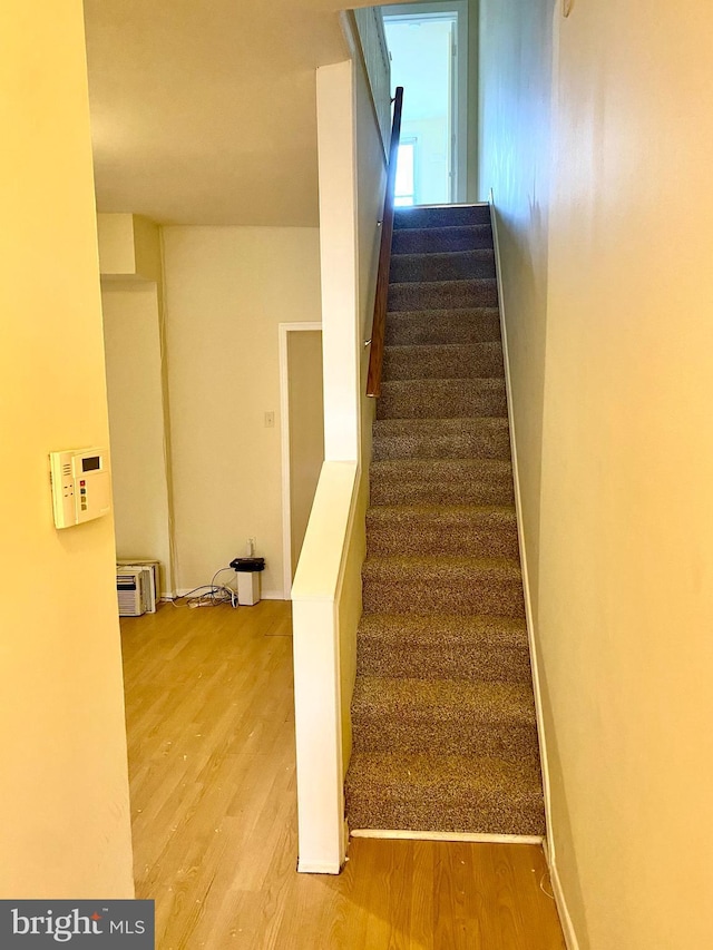 stairway featuring hardwood / wood-style floors