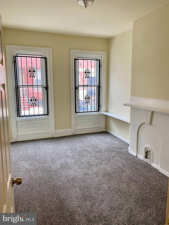 unfurnished living room featuring carpet