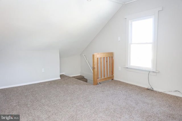 bonus room featuring lofted ceiling and carpet flooring