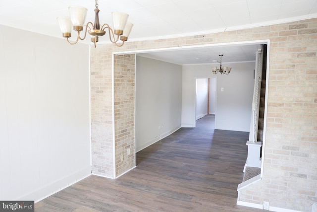 hall featuring an inviting chandelier, crown molding, and dark hardwood / wood-style flooring