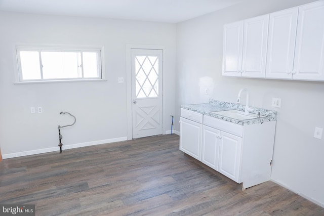 laundry room featuring sink and dark hardwood / wood-style flooring