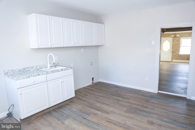 clothes washing area featuring sink, hookup for a washing machine, cabinets, and dark wood-type flooring