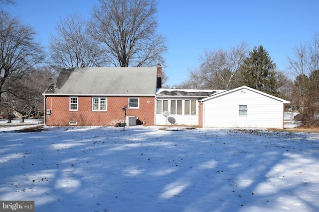 snow covered property featuring central AC