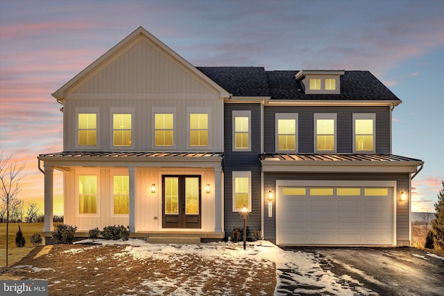 view of front of home with a garage and a porch