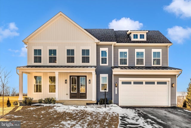 view of front of property featuring a garage and a porch