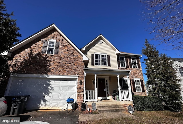 view of front of property featuring covered porch and a garage