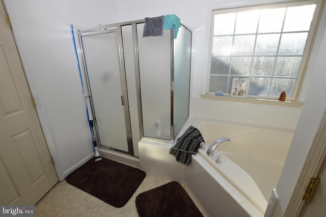 bathroom with tile patterned flooring and separate shower and tub