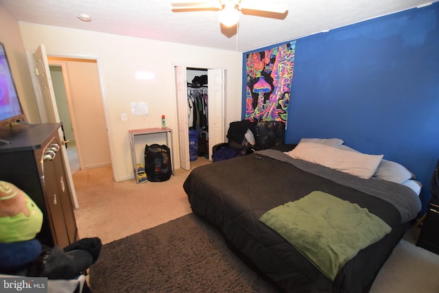 bedroom with ceiling fan, a closet, and light carpet