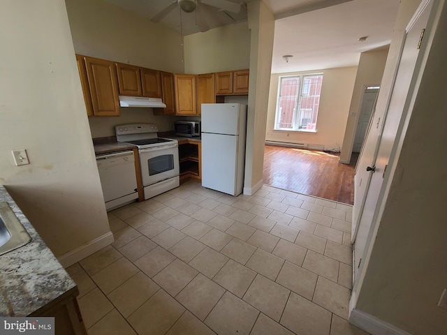 kitchen featuring ceiling fan, a baseboard radiator, white appliances, and light tile patterned floors