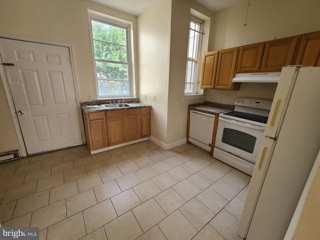 kitchen with light tile patterned floors, sink, and white appliances