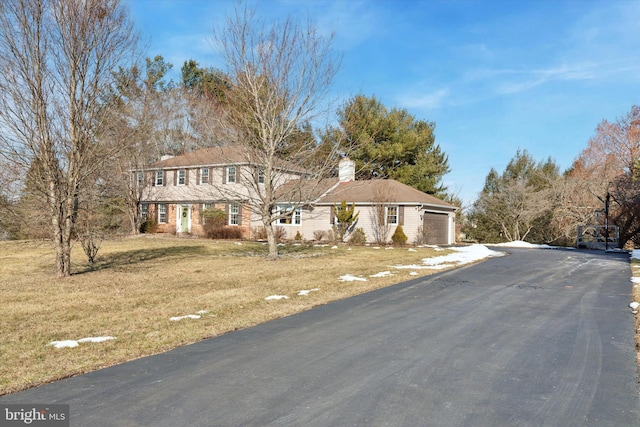 view of front of property with a garage and a front yard