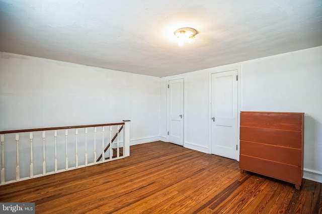 additional living space featuring dark hardwood / wood-style floors