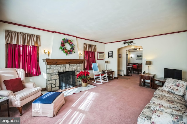 living room with a stone fireplace, radiator heating unit, carpet, and an AC wall unit