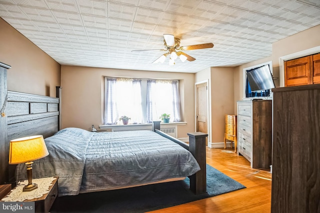 bedroom featuring ceiling fan and light hardwood / wood-style flooring