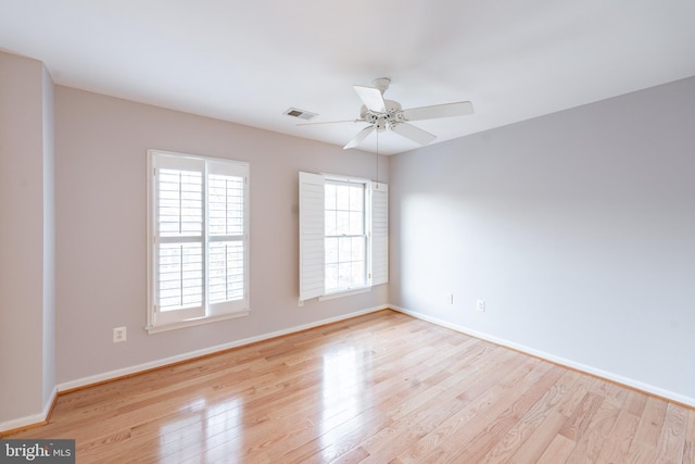 empty room with ceiling fan and light wood-type flooring